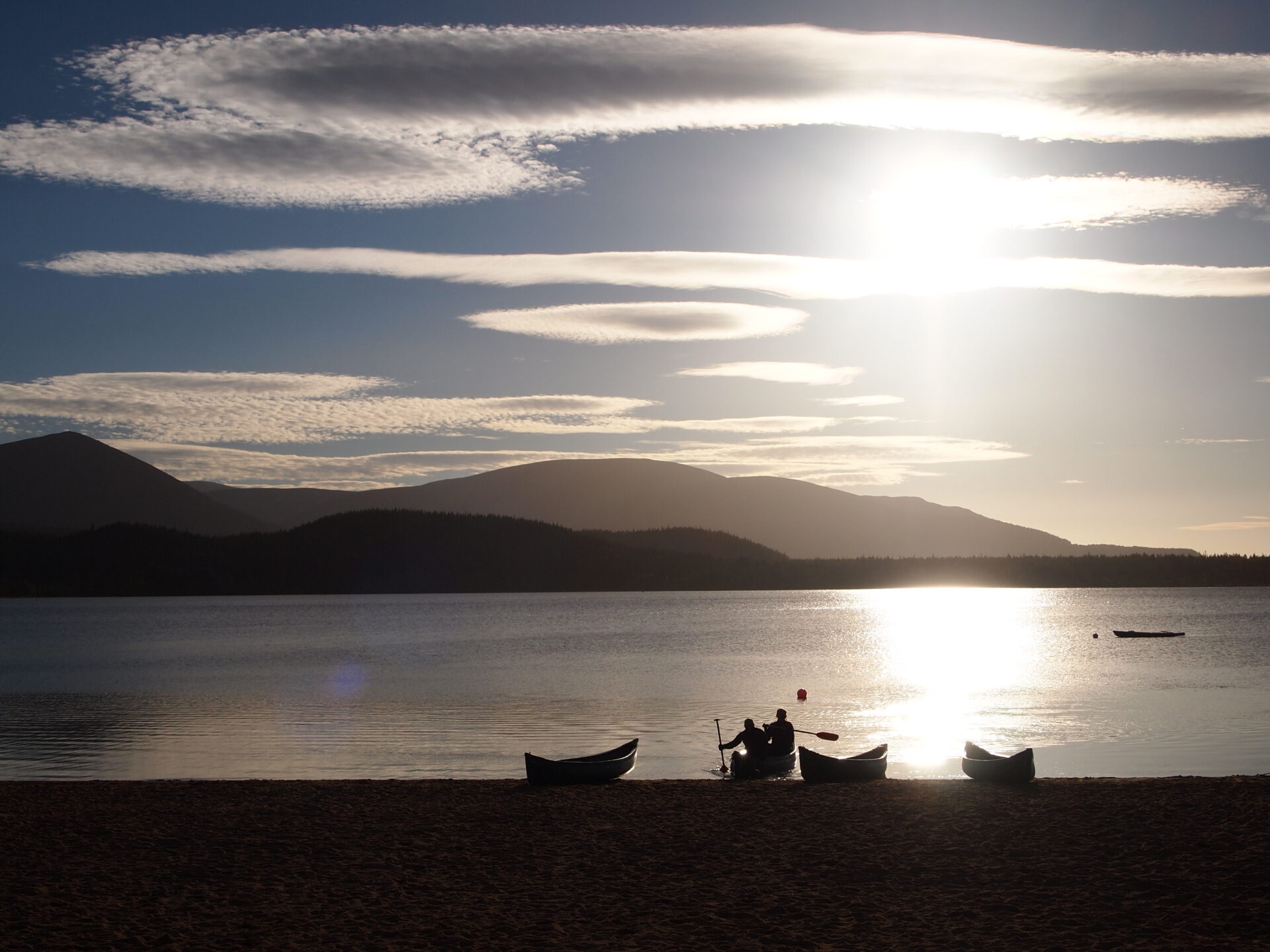 Loch Morlich at sunset with canoes.